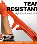 Person stretching 8 Mil Nitrile Powder Free Gloves Diamond Textured Heavy Duty Orange 100Pcs, showcasing tear resistance.