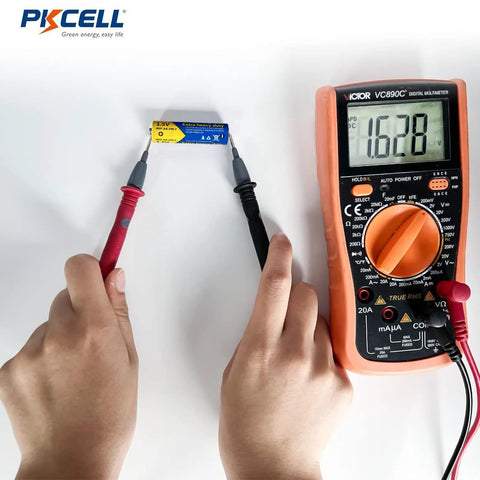 Hands using a multimeter to test AA And AAA Battery Combo Pack 80 Count 1.5V Carbon Zinc High Energy Batteries voltage.