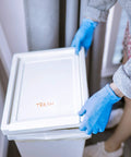 Person wearing Textured Blue Nitrile Gloves 5 Mil Powder Free Food Safe Large Box Of 100 handling trash lid
