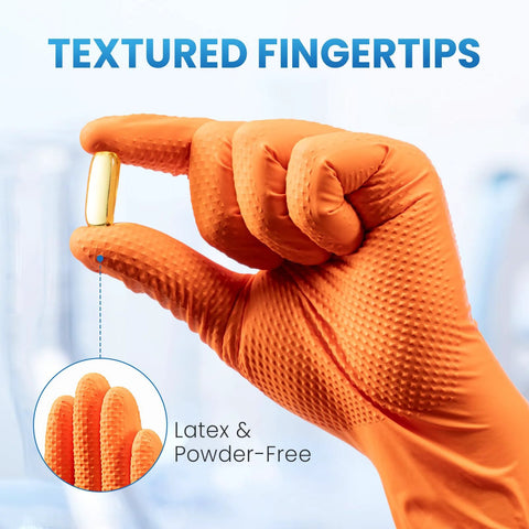 Close-up of orange nitrile glove holding a capsule, showing textured fingertips for grip. 8 Mil Nitrile Disposable Gloves Heavy Duty Mechanic Large 100 Count Powder Free.