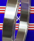 VG060CP0 Thin Section Slim Ball Bearing 6" x 8" x 1" inch chrome steel outer ring side view against a blue and red background.