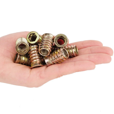 Hand holding Heavy Duty 40 Pack Threaded Inserts For Wood Furniture Three Eighths Sixteen Thread Size 25mm With Hex Spanner Socket Drive