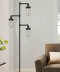 Three Head Steampunk Floor Lamp With Birdcage Shade Dope Industrial Rustic Edison Bulb Black Finish And Adjustable Cross Stand For Farmhouse Or Loft Living Room Decor By CONCA standing in a living room corner next to a chair.