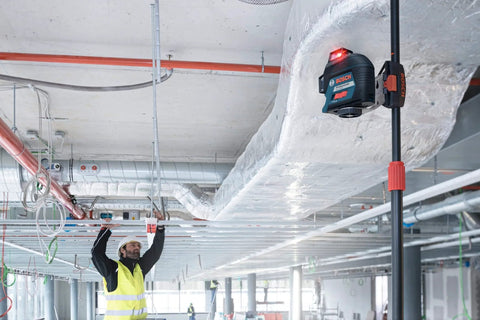 Clear room layout fast with a 360 degree three plane laser delivering bright alignment lines mounted in construction site