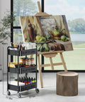 Three Tier Rolling Cart On Wheels, Heavy Duty Metal Utility Trolley With Lockable Wheels next to an art easel