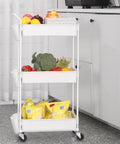 Three Tier Utility Rolling Cart With Lockable Caster Wheels And Three Hanging Baskets in a kitchen setting