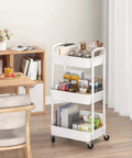 Three Tier Rolling Utility Cart With Handle For Office Kitchen And Living Room Grab And Go Moveable Storage Trolley On Wheels White Heavy Duty Plastic And Iron Frame Lockable Wheels Easy To Move And Organize in living room setting.