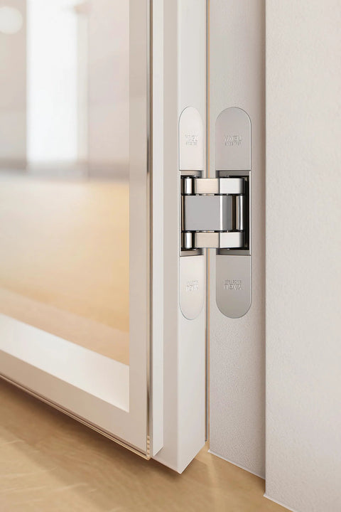 Three Way Adjustable Invisible Hinges For Hidden Doors, sleek zinc alloy, shown installed on a door, 180 degree swing, matte silver finish.