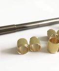 Pro Grade Throttle Shaft Bushing Repair Kit For Three Eighths Carbs, Includes Eight Brass Bushings And One Carbon Steel Reamer on white background