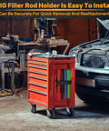 4 Slot TIG Welding Rod Holder Storage Rack mounted on red mobile tool cart in garage with visible car and welding tools