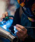 Close-up of ER308L Stainless Steel TIG Welding Rods 1 Sixteenth Inch by 16 Inch in use by welder with helmet