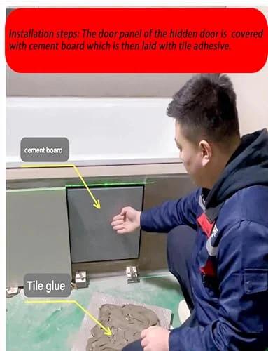 Person installing cement board on hidden door with tile adhesive for bathroom panel, displaying hinge placement under board.
