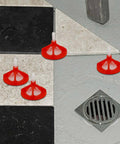 One Eighth Inch Tile Leveling System with red reusable caps installed on a tiled floor, showing spiral spacers in use.