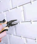 Installing 500 Piece Wide Tile Spacers And Levelers Set for ceramic tiles with pliers. Cross spacers maintain 1/8 inch gaps.