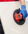 Battery Powered Tile Vacuum Suction Cup Tool for Handling Ceramic and Porcelain Tiles 220 mm grip in use by worker