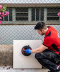 Professional using Battery Powered Tile Vacuum Suction Cup Tool for handling ceramic tiles, 220 mm grip, up to 140 kg capacity