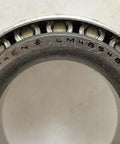 Close-up view of a TIMKEN LM48548 Tapered Roller Bearing showing inner cone and rollers.