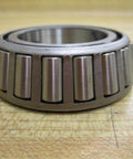 Side view of TIMKEN LM48548 Tapered Roller Bearing showing rollers and inner cone, suitable for heavy-duty use.