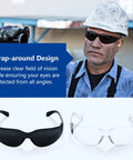 Worker wearing Tinted Safety Glasses Bulk 24 Pack With UV Protection Dark Smoke Lenses, wraparound, alongside clear version.
