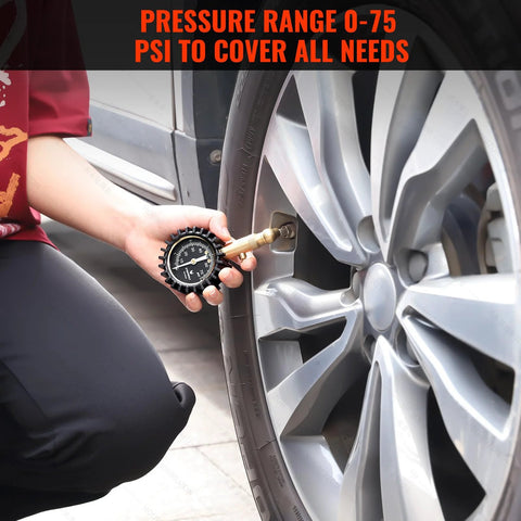 Tire Pressure Gauge 0-75 PSI With Large Glow Dial Calibrated To ANSI B40.1 checking car tire in a garage setting