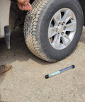 Heavy Duty Tire Repair Kit 21-Piece All-In-One Tire Plug Kit in use on car tire, showing repair on driveway surface.