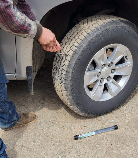 Person using Tire Repair Kit Bundle With Knife Included And Insertion Tool, fixing flat tire on vehicle