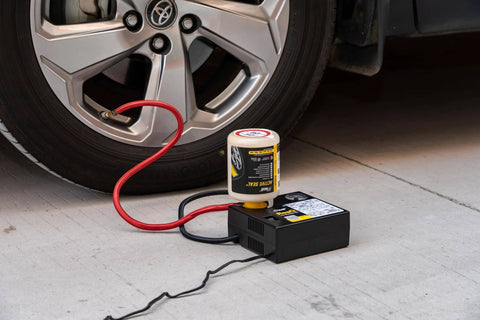 ResQ Tire Repair Kit with 12V Air Compressor and Cigarette Lighter Plug connected to car tire for emergency repair