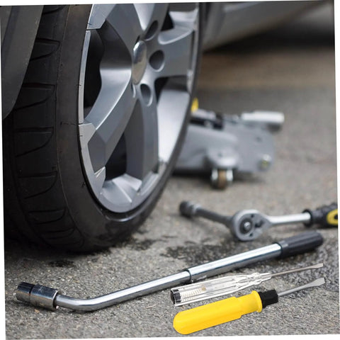 Multifunction Home Repair Tool Kit With Handy Storage Case For DIY Projects And Maintenance next to a car wheel on pavement