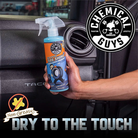 Hand holding 16 oz Tire Kicker Sprayable Extra Glossy Tire Shine Spray, restores wet look to rubber, vinyl, and plastic, dry to touch.