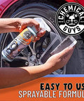 Tire Kicker Sprayable Extra Glossy Tire Shine Spray 16 oz being applied to a car tire for a wet look and long-lasting gloss.