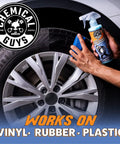Person applying Tire Kicker Sprayable Extra Glossy Tire Shine Spray Dry To Touch Dressing Restores Wet Look To Rubber Vinyl And Plastic Safe For Cars Trucks Motorcycles RVs And More With Long Lasting Gloss And Fade Resistant Finish 16 Oz to car tire.