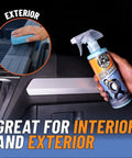 Person holding Tire Kicker Sprayable Extra Glossy Tire Shine Spray Dry To Touch Dressing Restores Wet Look To Rubber Vinyl And Plastic Safe For Cars Trucks Motorcycles RVs And More With Long Lasting Gloss And Fade Resistant Finish 16 Oz, illustrating application on vehicle interior.