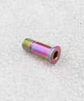 Close-up of ECSiNG titanium alloy fixing screw for bicycle derailleur bolt, multicolor