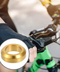 Cyclist gripping handlebar with inset of Partuto 4 Pcs M6x5.5 Universal Bicycle Bolt Brake Screw Washer Bolts in titanium alloy gold tone.