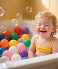 Toddler smiling in bath with Ball Pit Balls for Toddles Kids Plastic Ballpits Accessories Crush Proof Durable Fun Shape Play Baby Bath Toys,2.15inch 100count Mix Color