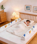 Child sleeping in bed with 2 Pack Premium Foam Toddler Bed Bumpers With Non Slip Rails For Twin Queen And King Beds Cozy Odor Free Comfort Machine Washable Covers Easy Care 52 By 7 By 5 Inches Safe Sleep Aid For Peaceful Nights installed