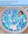 Child playing in ball pit with BPA Free Crush Proof Plastic Toy Balls for Ball Pit in white, green, and blue