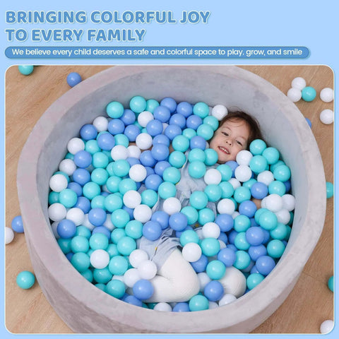 Child playing in ball pit with BPA Free Crush Proof Plastic Toy Balls for Ball Pit in white, green, and blue