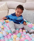Toddler playing with BPA Free Crush-Proof Plastic Ball Pit Balls, Pack of 400 Balls, 6 Pastel Colors, for Kids 12+ Months, with Storage Bag