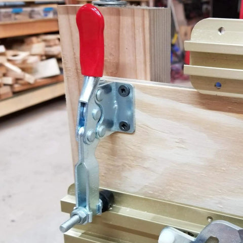 Installed Heavy Duty 12 Pack 201B Toggle Clamp For Woodworking, galvanized iron, red antislip handle, securing wooden piece.