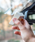 Installing Toll Tag Mounting Kit For EZ Pass I Pass SunPass With Alcohol Prep Pad using adhesive strips on a car windshield