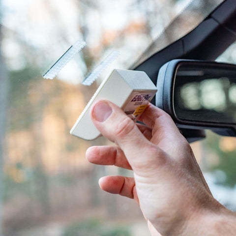 Installing Toll Tag Mounting Kit For EZ Pass I Pass SunPass With Alcohol Prep Pad using adhesive strips on a car windshield