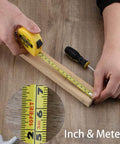 Hands using a measuring tape from 24 Piece Homeowner Tool Set With Portable Tool Bag For Everyday Home Fixes, Ergonomic TPR Handles.