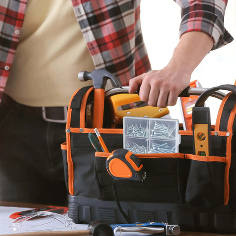 Person reaching for tools in bag with Wood Screws Assortment Kit 152 Pcs Silver Phillips Screws visible on table