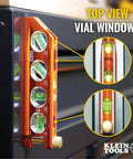Compact 6-Inch magnetic torpedo level with a V-groove for conduit work delivers hands-free stability on metal surfaces, close-up of vial markers and thumb screw attachment on black surface