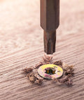 Installation of M2-0.4 x 4mm Flat Torx Head Machine Screw with screwdriver in wooden surface, showing flush finish and grip