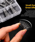 Close-up of a hand holding a spring from the 123-Piece Tower Conical Spring Set With 10 Sizes Go-To, showcasing tapered design.