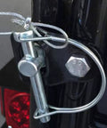 Close-up of Ten Pack One Quarter By Four Inch Trailer Coupler Pin Set Heavy Duty Locking Towing Pin Safety Pin in use on trailer.