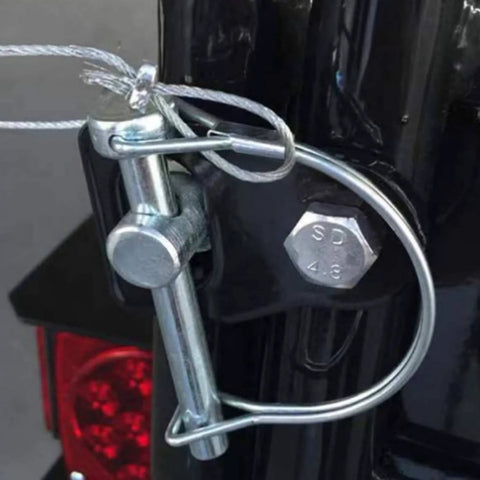 Close-up of Ten Pack One Quarter By Four Inch Trailer Coupler Pin Set Heavy Duty Locking Towing Pin Safety Pin in use on trailer.