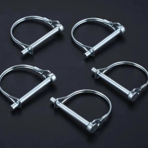 Set of five silver trailer coupler pins on black background, from Ten Pack One Quarter By Four Inch Trailer Coupler Pin Set Heavy Duty Locking Towing Pin Safety Pin For Trailers Lawn And Garden Equipment Farm Wagons Silver.